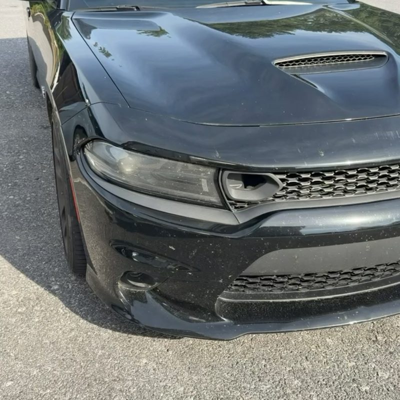 Dodge Charger before ceramic coating — dull, hazy black paint